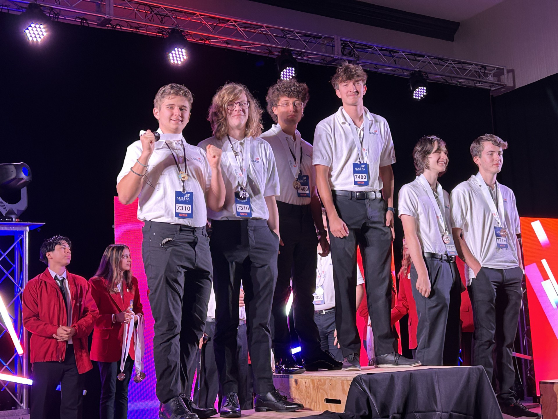A group of people on a stageDescription automatically generated